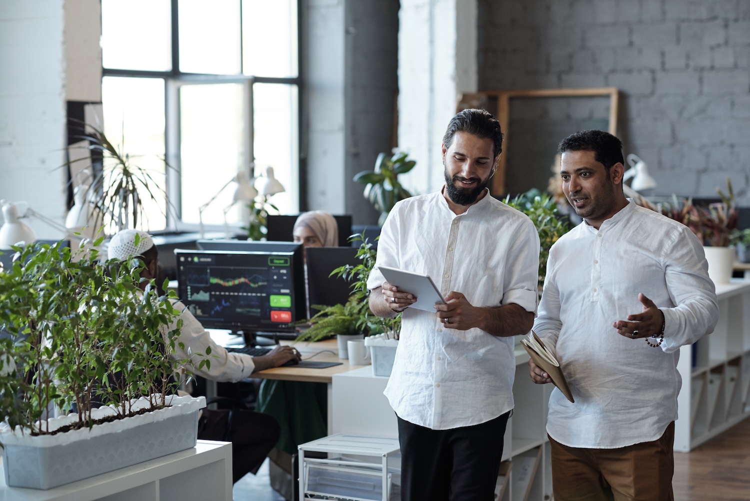 Two young Muslim businessmen preparing for presentation in office
